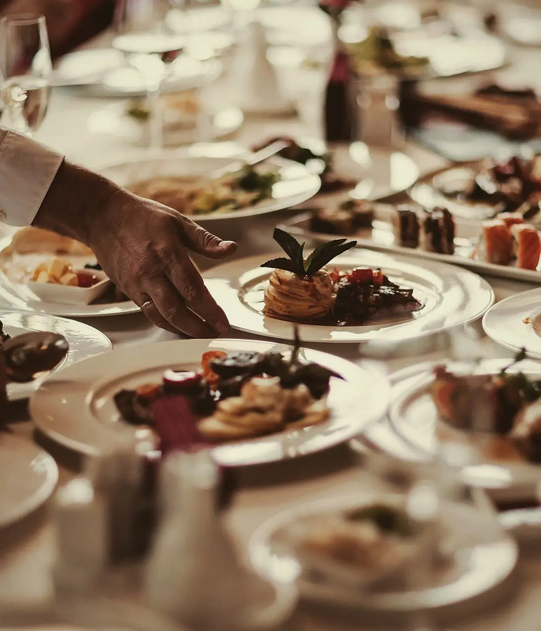 Plated dishes served to guests at a formal table