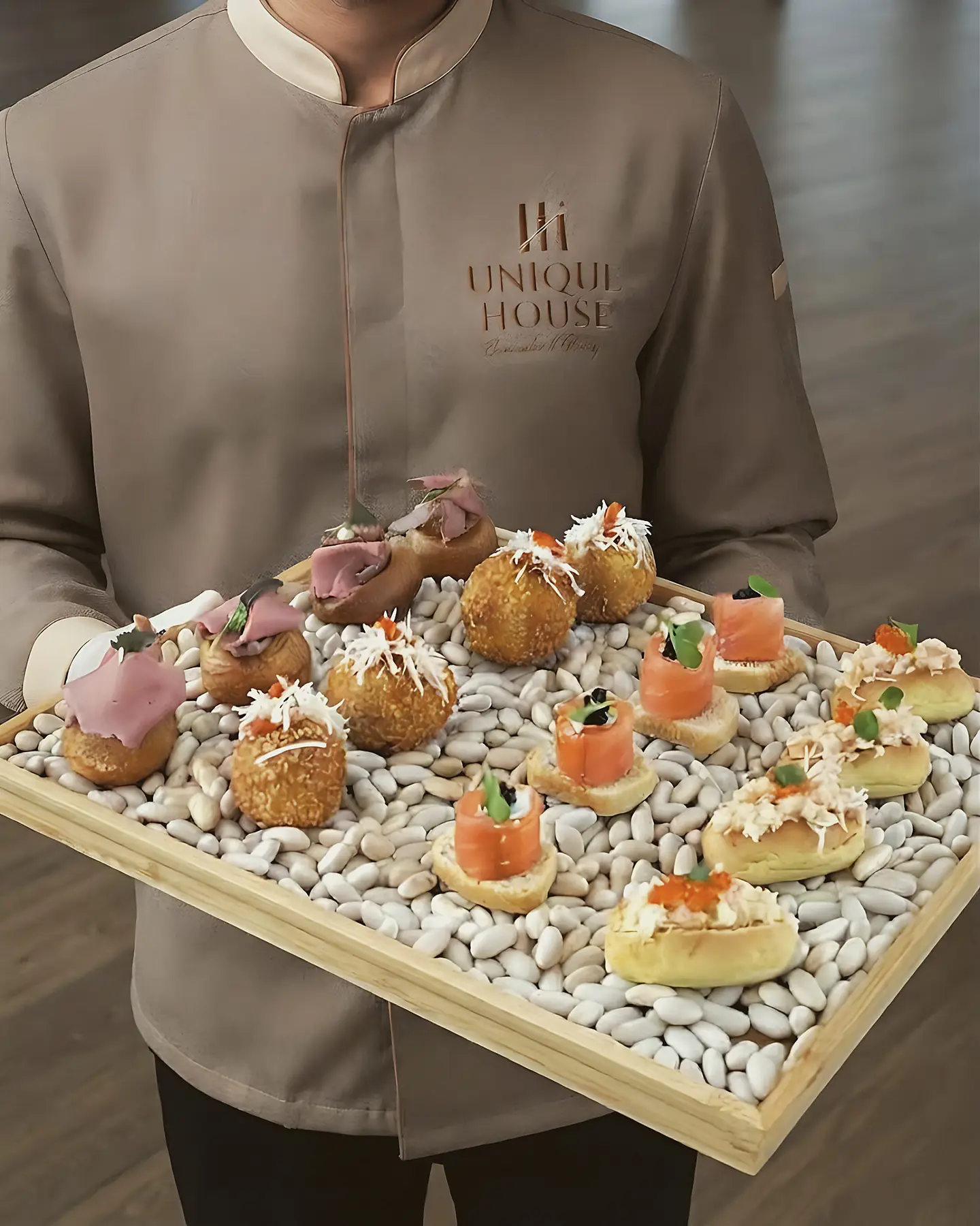 Unique House server carrying a tray of canapés